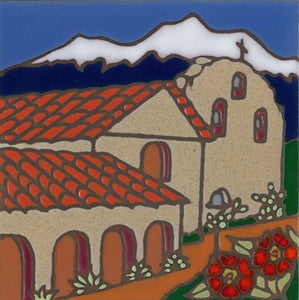 Ceramic tile with original art image of Mission Santa Ines Virgen y Martir hand painted & kiln fired creating vivid, jewel-like colors. American made, hand crafted tile has a hardboard backing making it suitable as a trivet, original wall art or without the backing,  combine several to form a tile mosaic back splash.